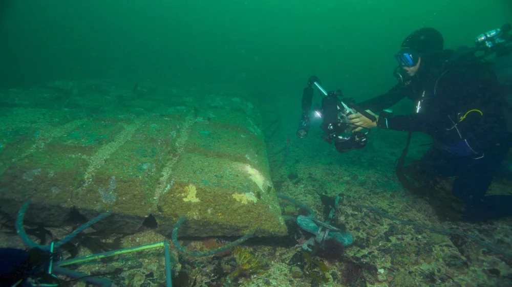 Diver checking underwater cable.