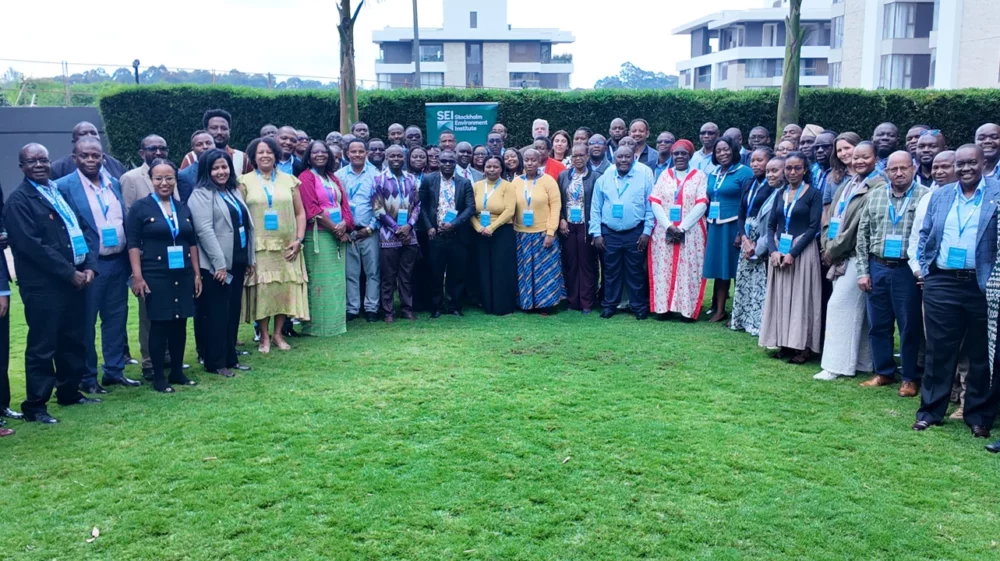 Group of people standing together on green grass