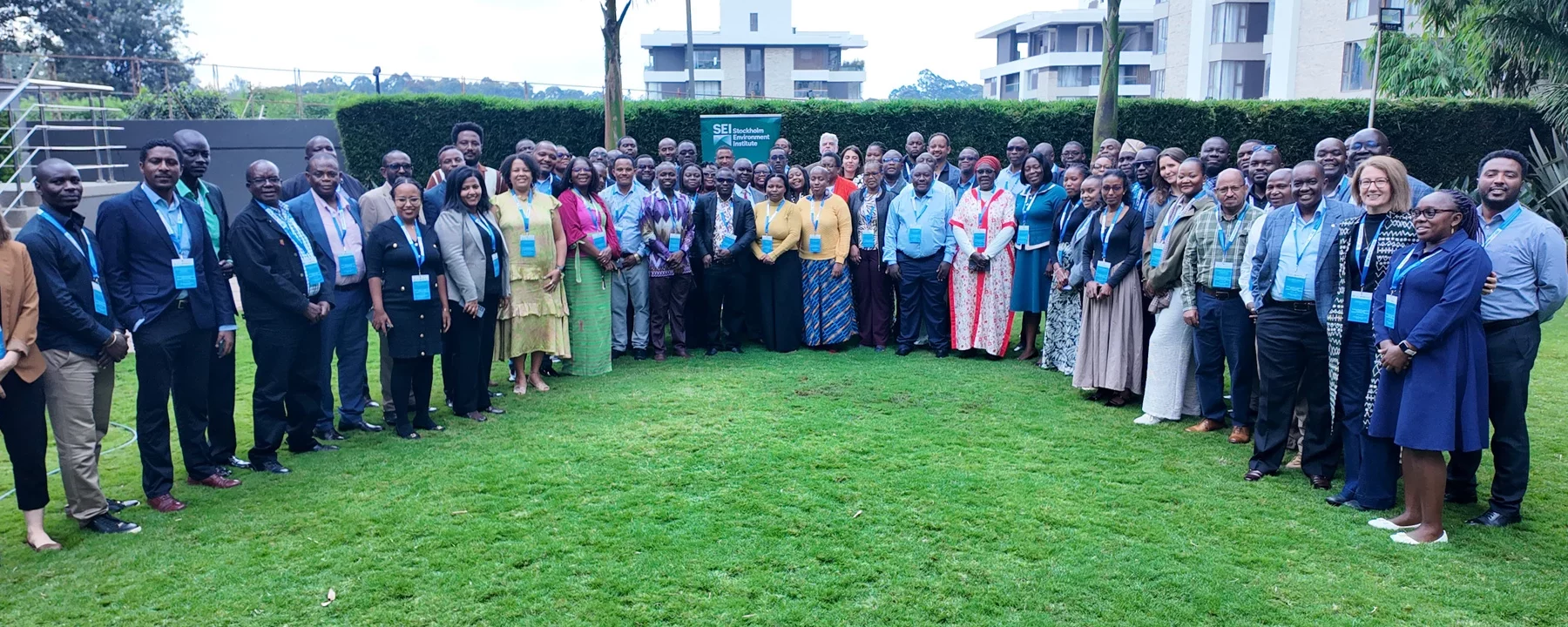 Group of people standing together on green grass