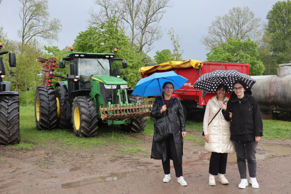 Participants in front of green tractor