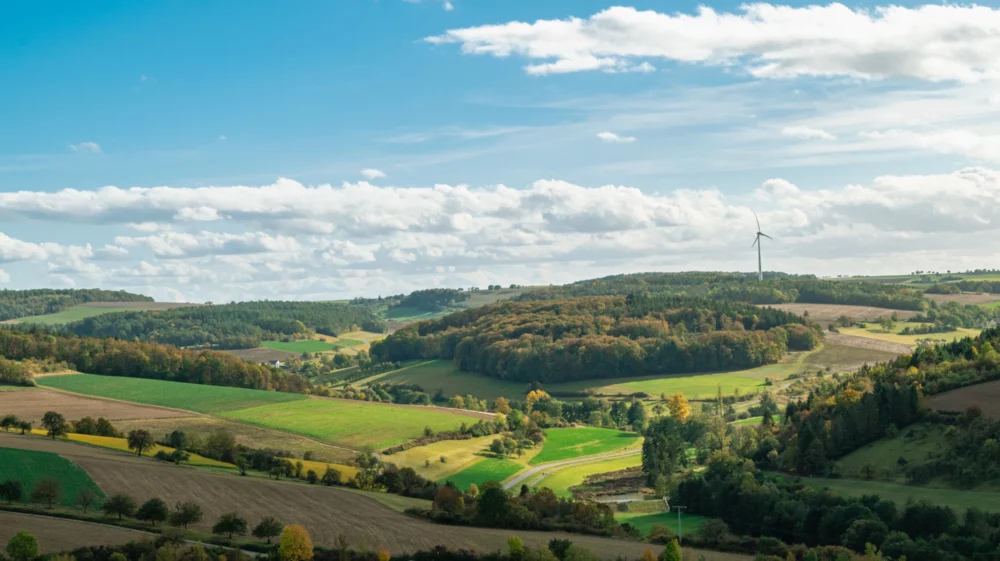 A panoramic view of rolling hills and wind turbines in autumn in Bad Mergentheim, Germany.