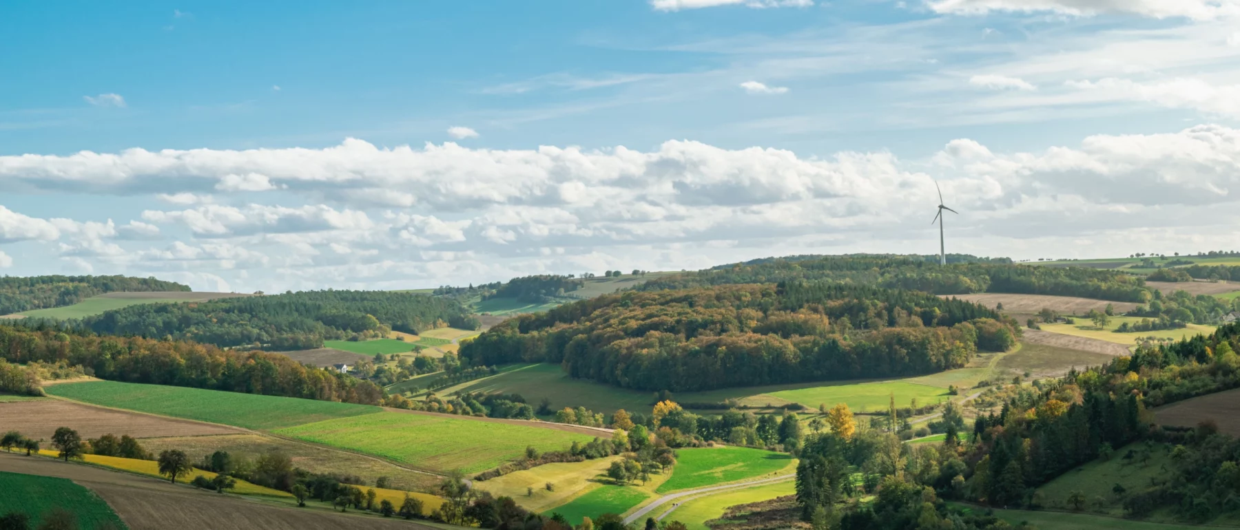 A panoramic view of rolling hills and wind turbines in autumn in Bad Mergentheim, Germany.