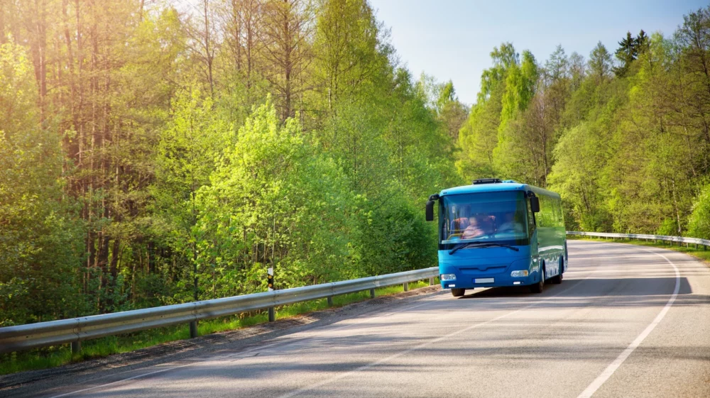 Bus on asphalt road in beautiful spring day at countryside.