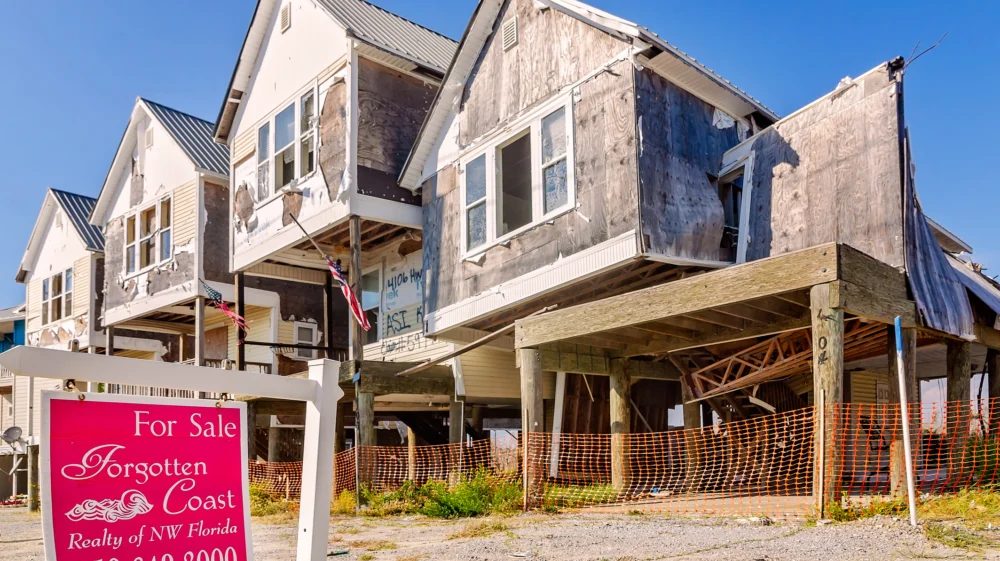 A realty sign stands outside condominiums damaged by Hurricane Michael in 2018 in Mexico Beach, Florida