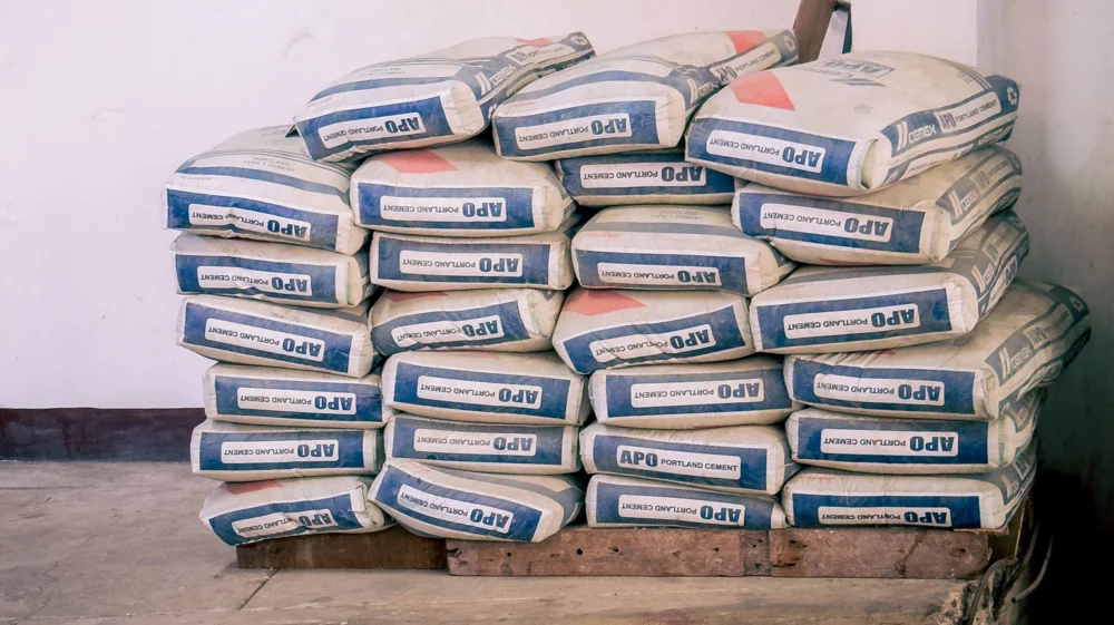 A large stack of white sacks with blue and red markings.