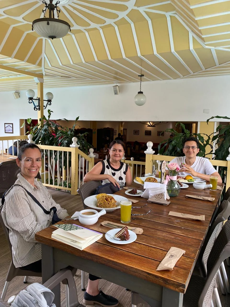Three people at a table in a cafe