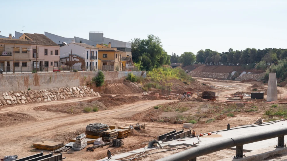 Reconstruction work occurring in the Barranco del Poyo riverbed, showing a flood recovery project