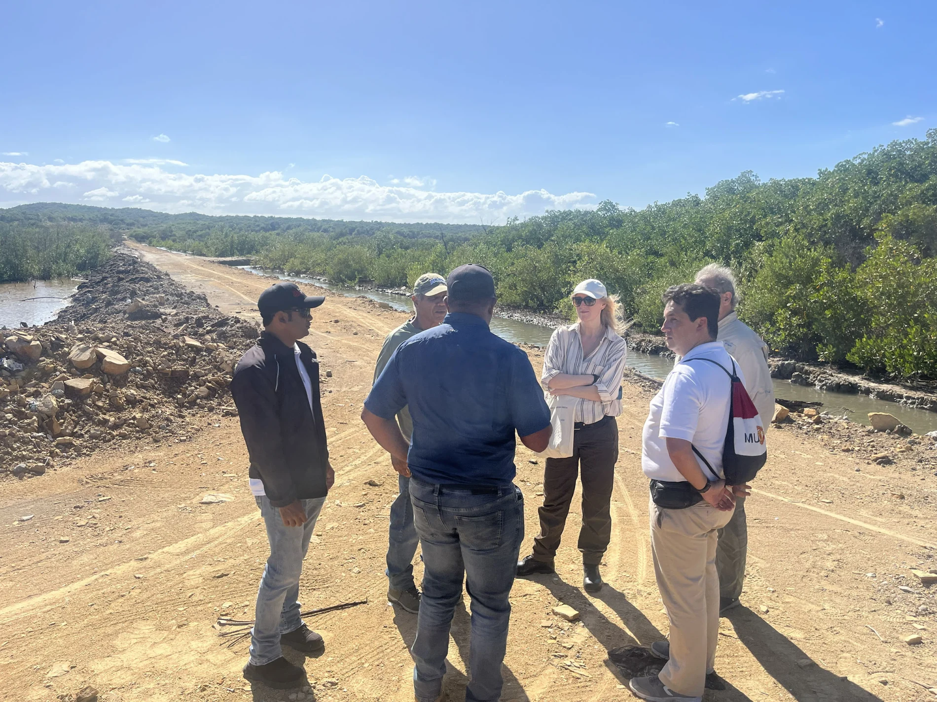 Group of people look at restored mangroves in Montecristi, Dominican Republic.